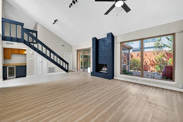 an empty room with a fireplace and lots of wooden floor