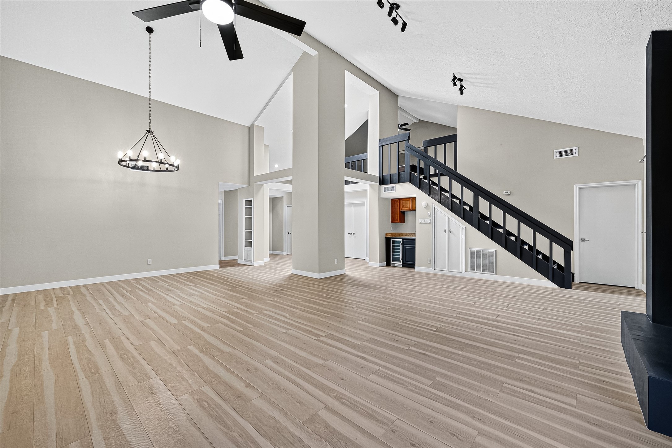 2026 Ashford Hollow Lane Houston, TX 77077 - Photo 2 of 35 a view of an empty room with wooden floor and a ceiling fan