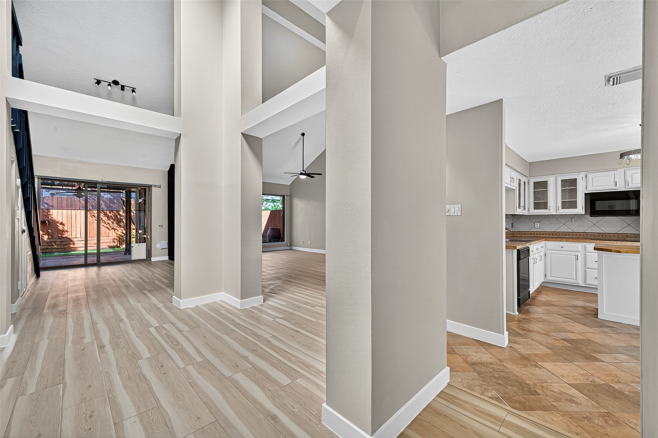2026 Ashford Hollow Lane Houston, TX 77077 - Photo 4 of 35 a view of a hallway with wooden floor and windows