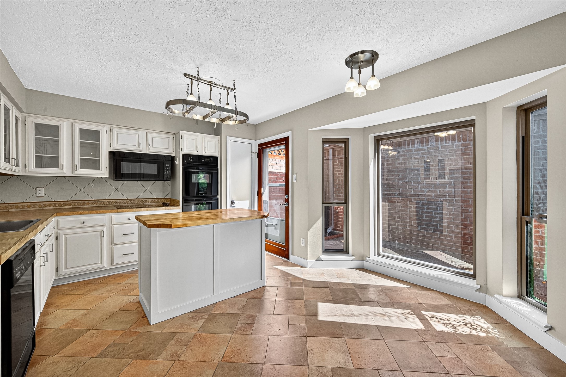 2026 Ashford Hollow Lane Houston, TX 77077 - Photo 5 of 35 a large kitchen with kitchen island granite countertop a large window in it