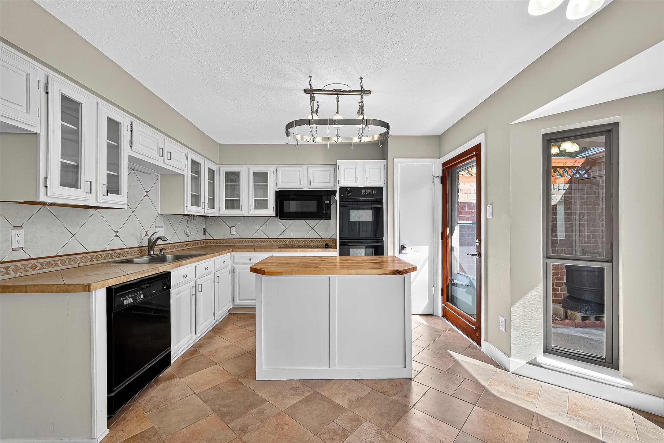 2026 Ashford Hollow Lane Houston, TX 77077 - Photo 6 of 35 a view of a kitchen with stainless steel appliances granite countertop a stove and a sink