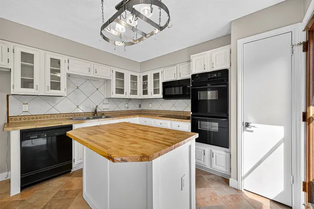 a view of a kitchen with stainless steel appliances granite countertop a stove and a sink