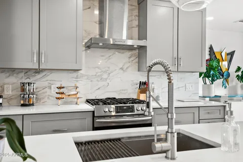 a kitchen with stainless steel appliances granite countertop a stove and a cabinets