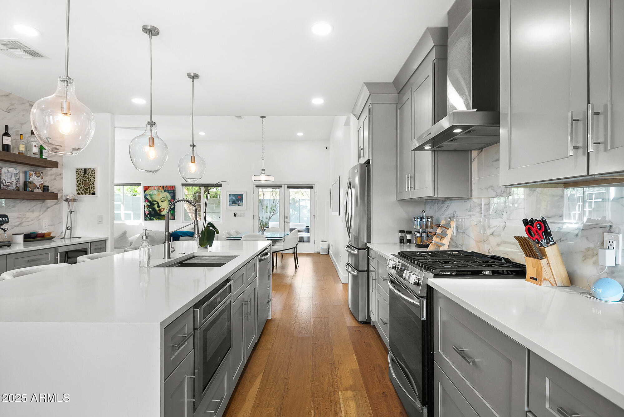 4526 East Heatherbrae Drive Phoenix, AZ 85018 - Photo 13 of 34 a kitchen with kitchen island granite countertop a sink a counter space appliances and cabinets
