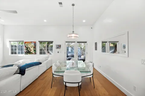 a dining room with furniture and wooden floor