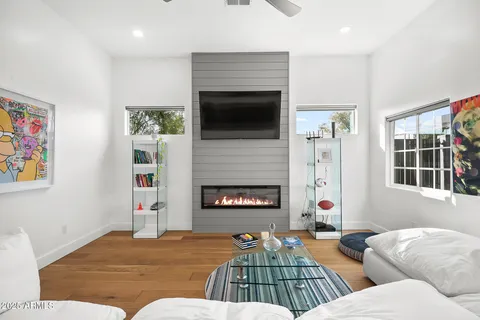 a living room with furniture fireplace and window