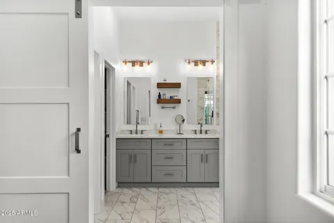 a spacious bathroom with a double vanity sink and a mirror
