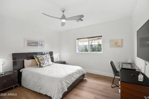 a bedroom with a bed and a desk