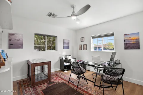 a workspace with wooden floor and windows