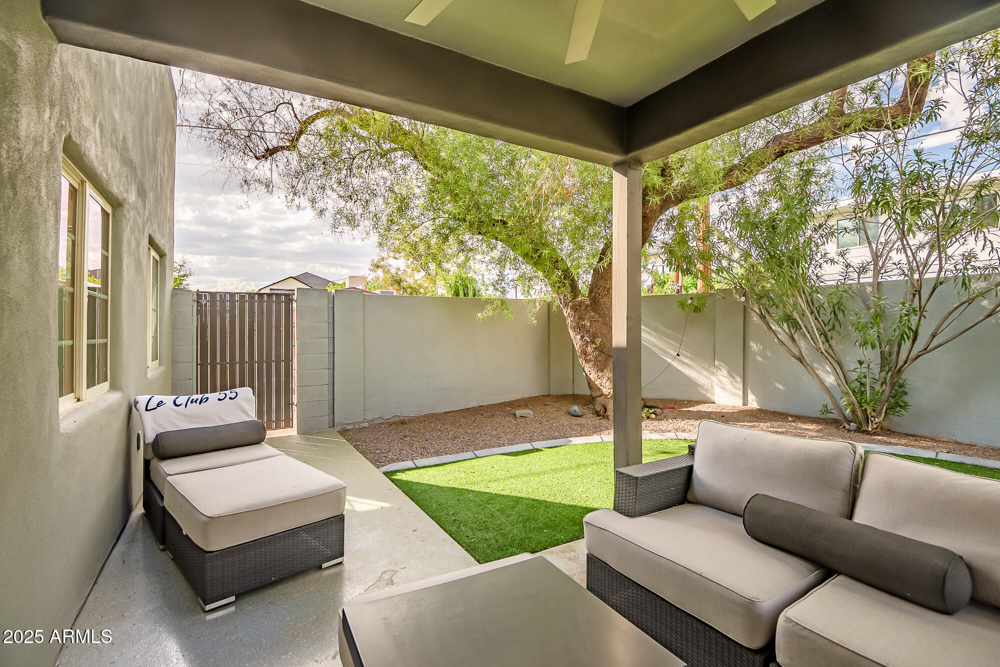 4526 East Heatherbrae Drive Phoenix, AZ 85018 - Photo 28 of 34 a living room with patio furniture and a garden