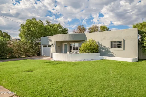 a view of a house with a yard and a patio