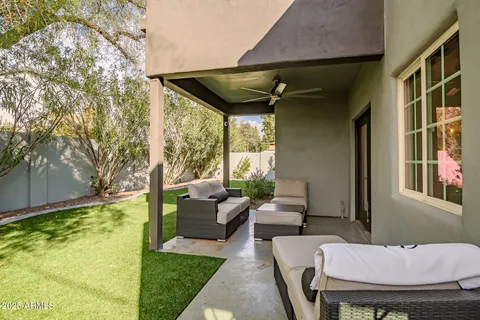 a backyard of a house with table and chairs