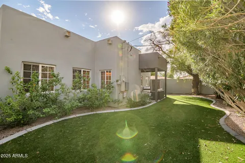 a view of a house with a yard and a garage