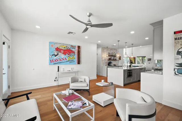 a living room with furniture and kitchen view