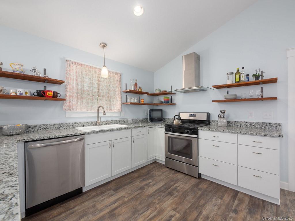249 Bane Road Mills River, NC 28759 - Photo 17 of 30 a kitchen with granite countertop white cabinets and white appliances