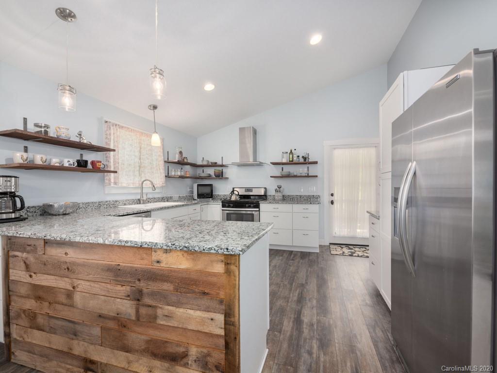 249 Bane Road Mills River, NC 28759 - Photo 19 of 30 a kitchen with stainless steel appliances granite countertop a refrigerator a sink a stove and a oven