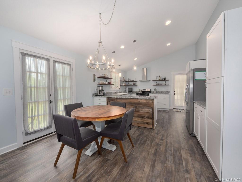 249 Bane Road Mills River, NC 28759 - Photo 21 of 30 a kitchen with stainless steel appliances a dining table chairs stove and refrigerator