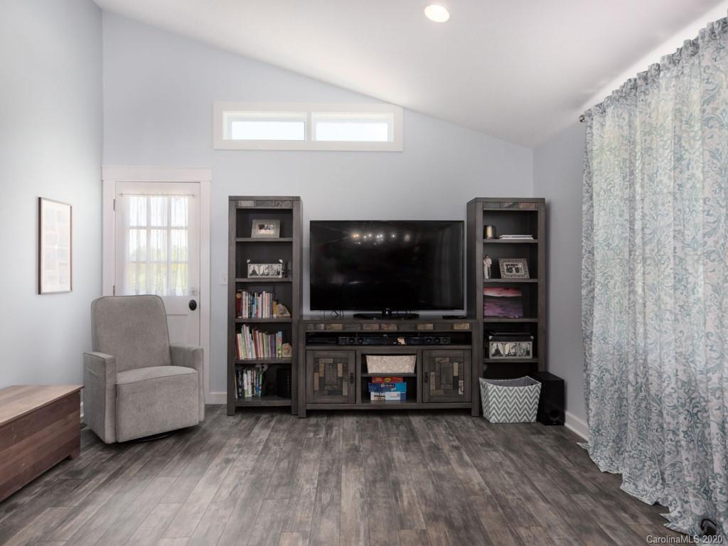 249 Bane Road Mills River, NC 28759 - Photo 22 of 30 a living room with furniture and a flat screen tv