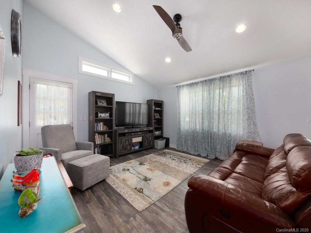 249 Bane Road Mills River, NC 28759 - Photo 24 of 30 a living room with furniture and a flat screen tv