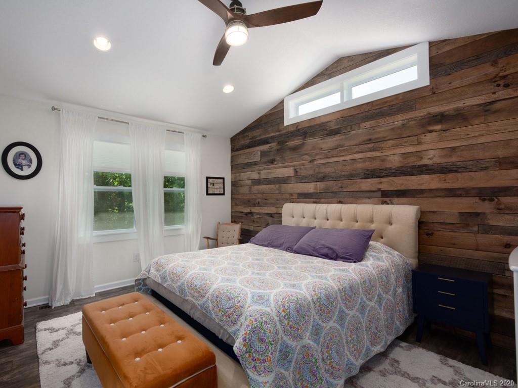 249 Bane Road Mills River, NC 28759 - Photo 25 of 30 a bedroom with a bed and a night stand