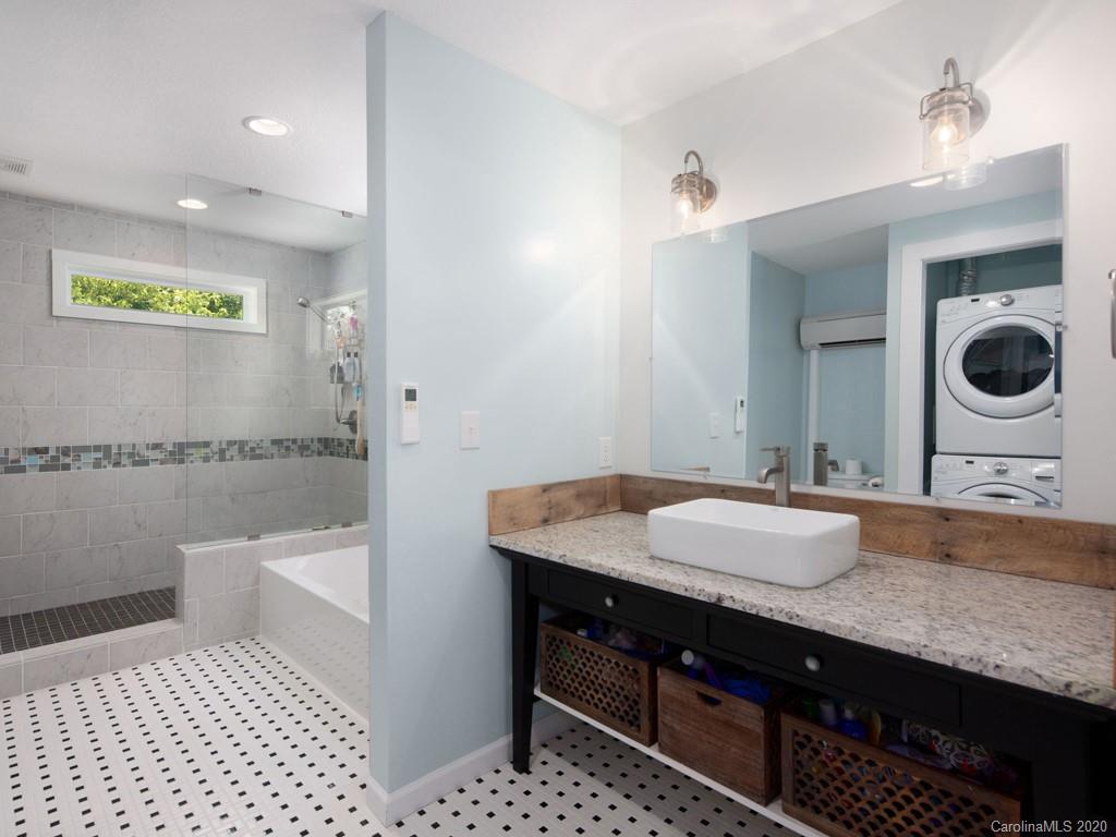 249 Bane Road Mills River, NC 28759 - Photo 26 of 30 a spacious bathroom with a granite countertop sink a toilet and a mirror