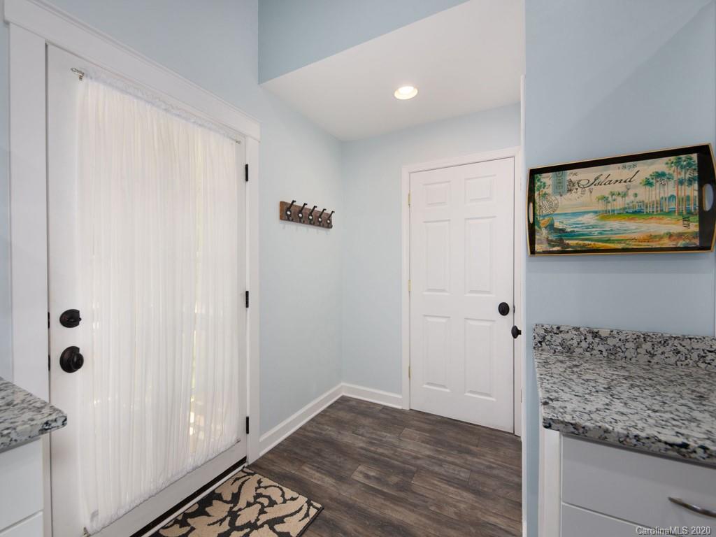 249 Bane Road Mills River, NC 28759 - Photo 28 of 30 a view of hallway with chandelier fan and wooden floor