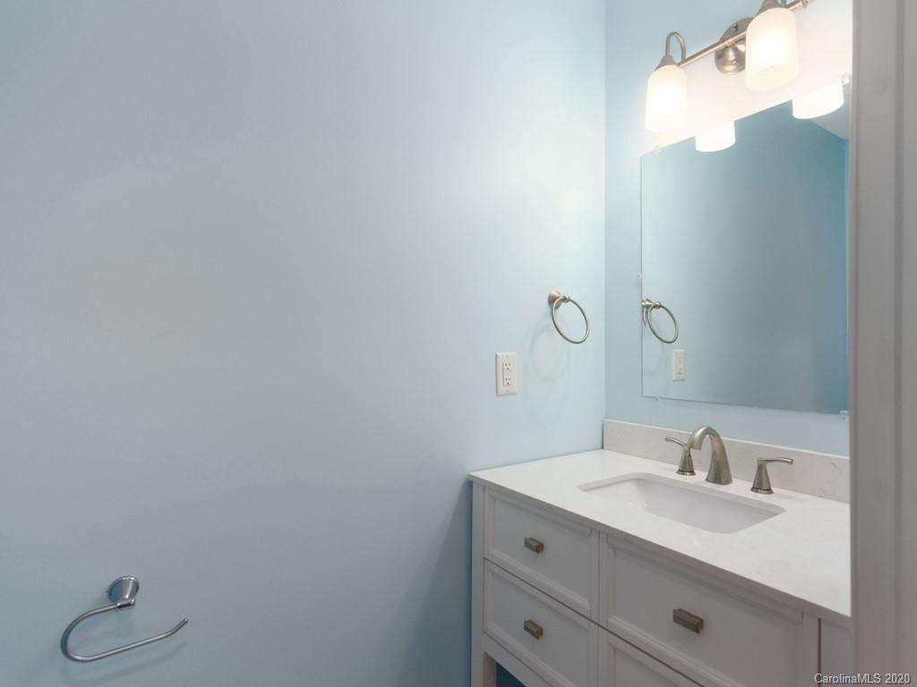 249 Bane Road Mills River, NC 28759 - Photo 29 of 30 a bathroom with a granite countertop sink vanity and a mirror