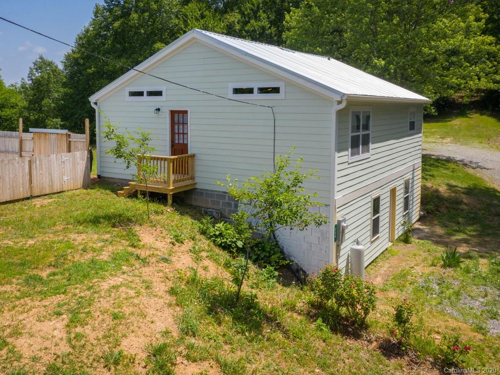 249 Bane Road Mills River, NC 28759 - Photo 10 of 30 a backyard of a house with table and chairs