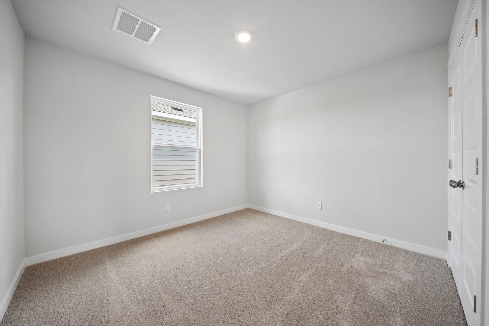 145 Hornet Street Elgin, TX 78621 - Photo 5 of 18 A well-proportioned bedroom with soft carpet and a simple window.