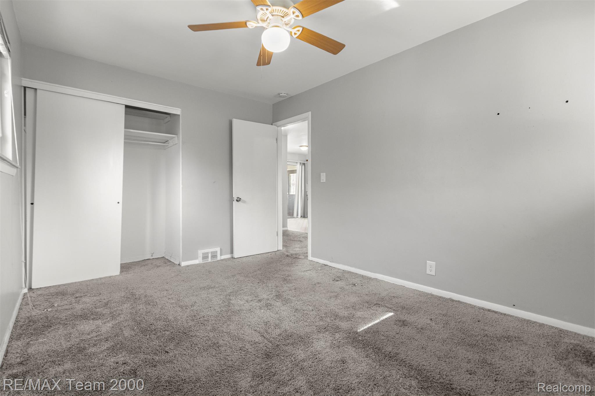 19431 Stephens Road Eastpointe, MI 48021 - Photo 29 of 46 Unfurnished bedroom featuring carpet flooring, a ceiling fan, and a closet