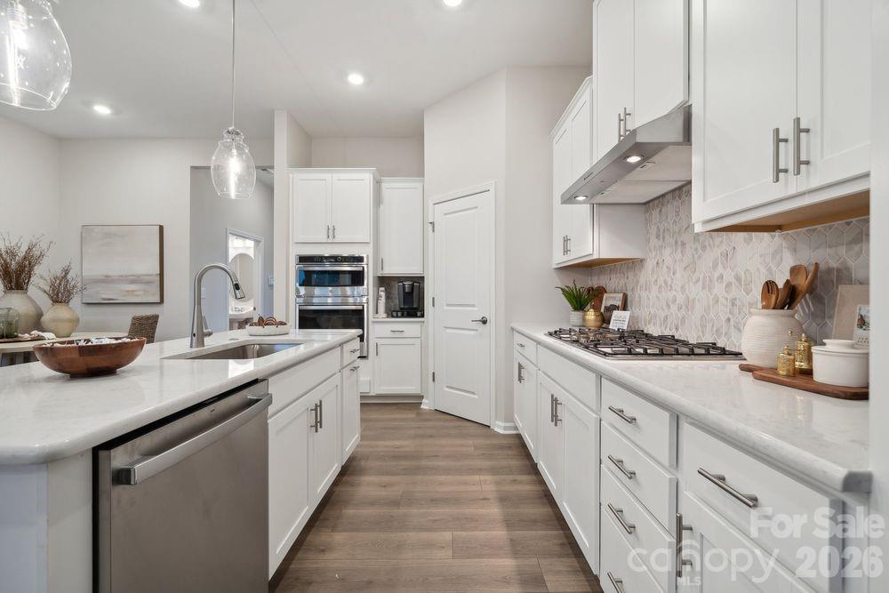 8671 Miles Gap Road Indian Land, SC 29707 - Photo 11 of 31 a kitchen with stainless steel appliances a sink stove and cabinets