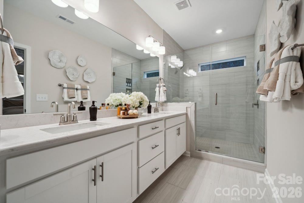 8671 Miles Gap Road Indian Land, SC 29707 - Photo 14 of 31 a bathroom with a double vanity sink mirror and shower