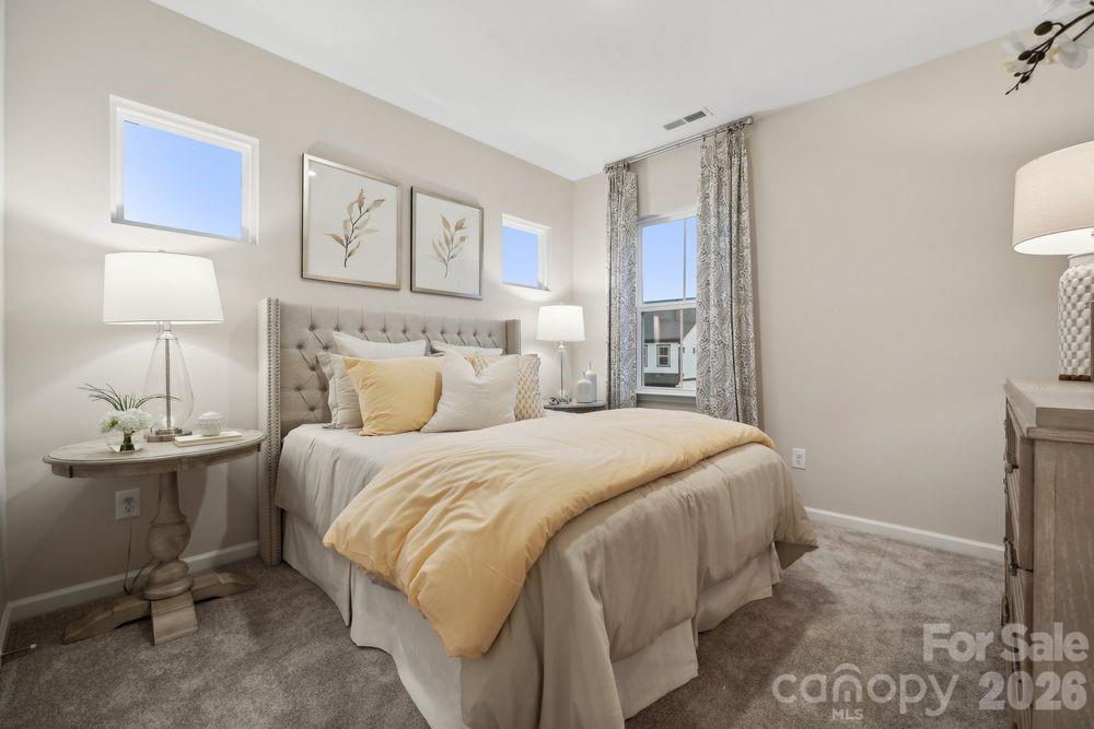 8671 Miles Gap Road Indian Land, SC 29707 - Photo 17 of 31 a bedroom with a bed and a lamp