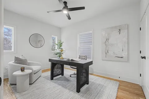 a living room with furniture and a wooden floor