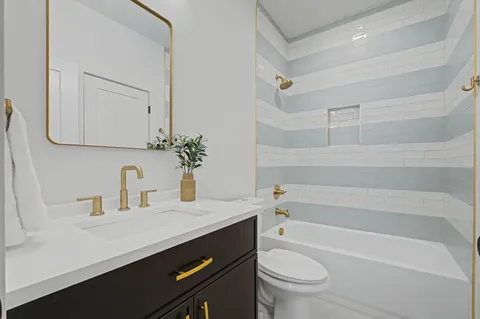 a bathroom with a sink a toilet and a bathtub