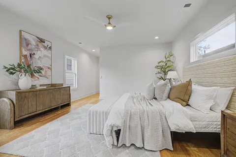 a bedroom with bed and ceiling fan