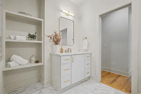 a bathroom with a sink vanity and mirror