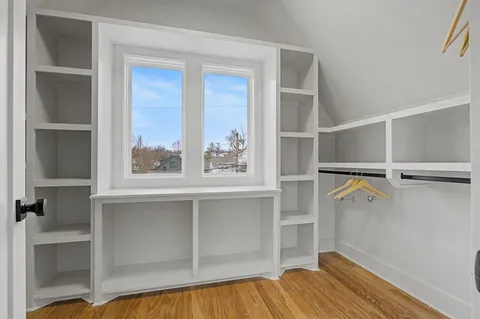 a view of walk in closet with empty racks