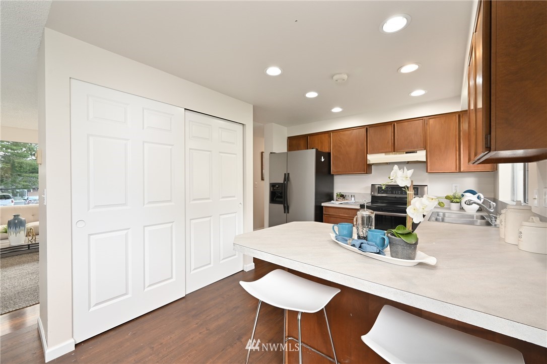 9211 3rd Place Southeast Everett, WA 98208 - Photo 12 of 33 a kitchen with refrigerator and chairs