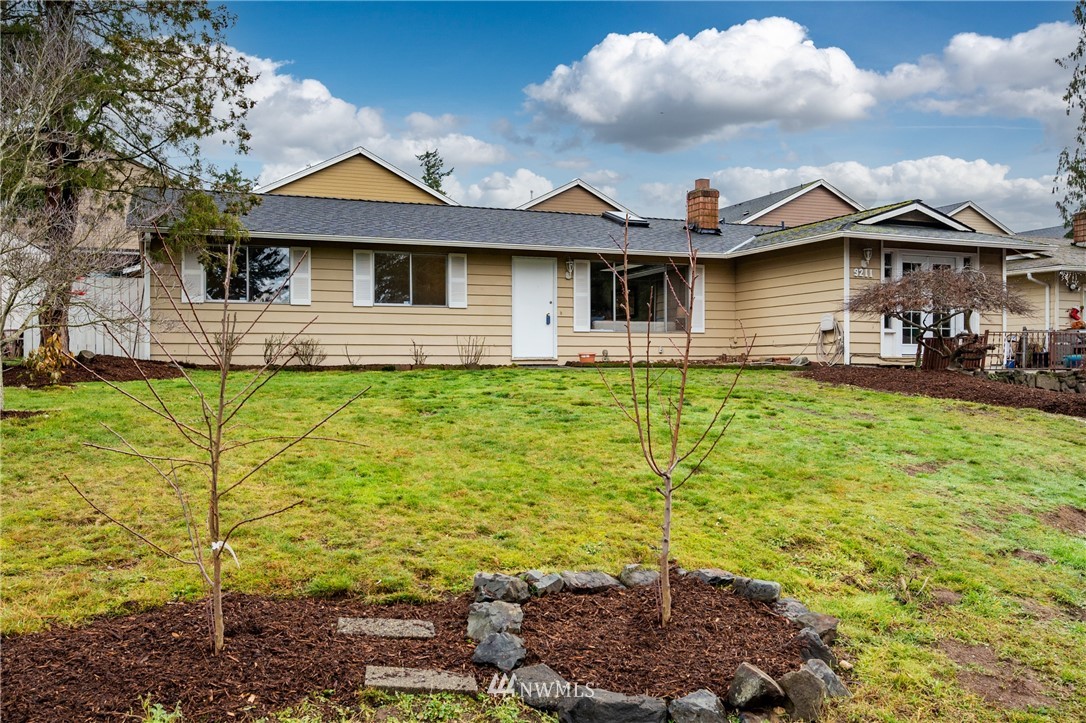 9211 3rd Place Southeast Everett, WA 98208 - Photo 2 of 33 a front view of a house with a yard