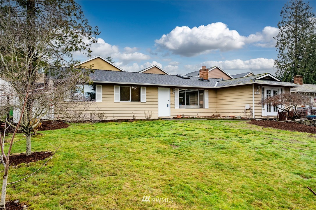 9211 3rd Place Southeast Everett, WA 98208 - Photo 3 of 33 a front view of a house with garden