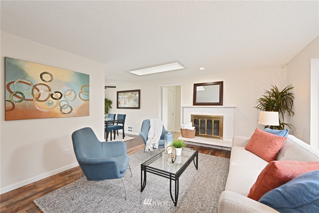 9211 3rd Place Southeast Everett, WA 98208 - Photo 6 of 33 a living room with furniture a fireplace and a potted plant