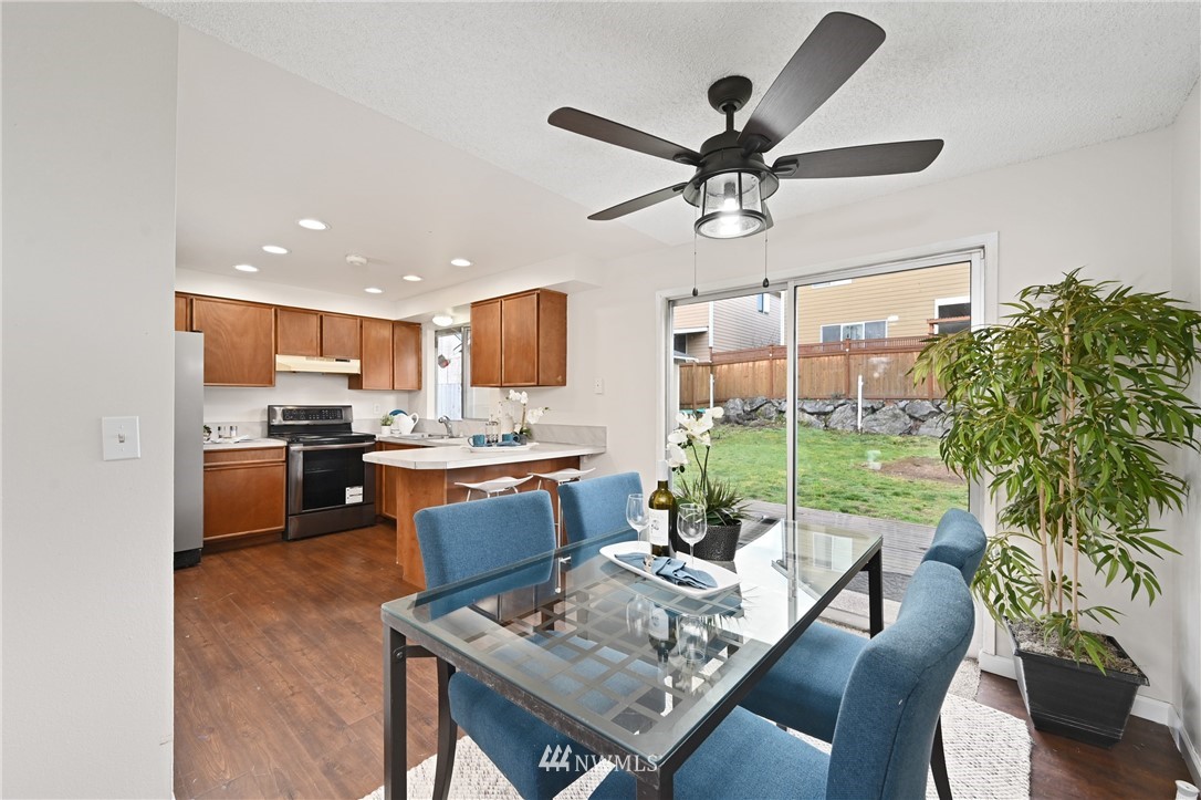 9211 3rd Place Southeast Everett, WA 98208 - Photo 10 of 33 a kitchen with a table chairs stove and kitchen view
