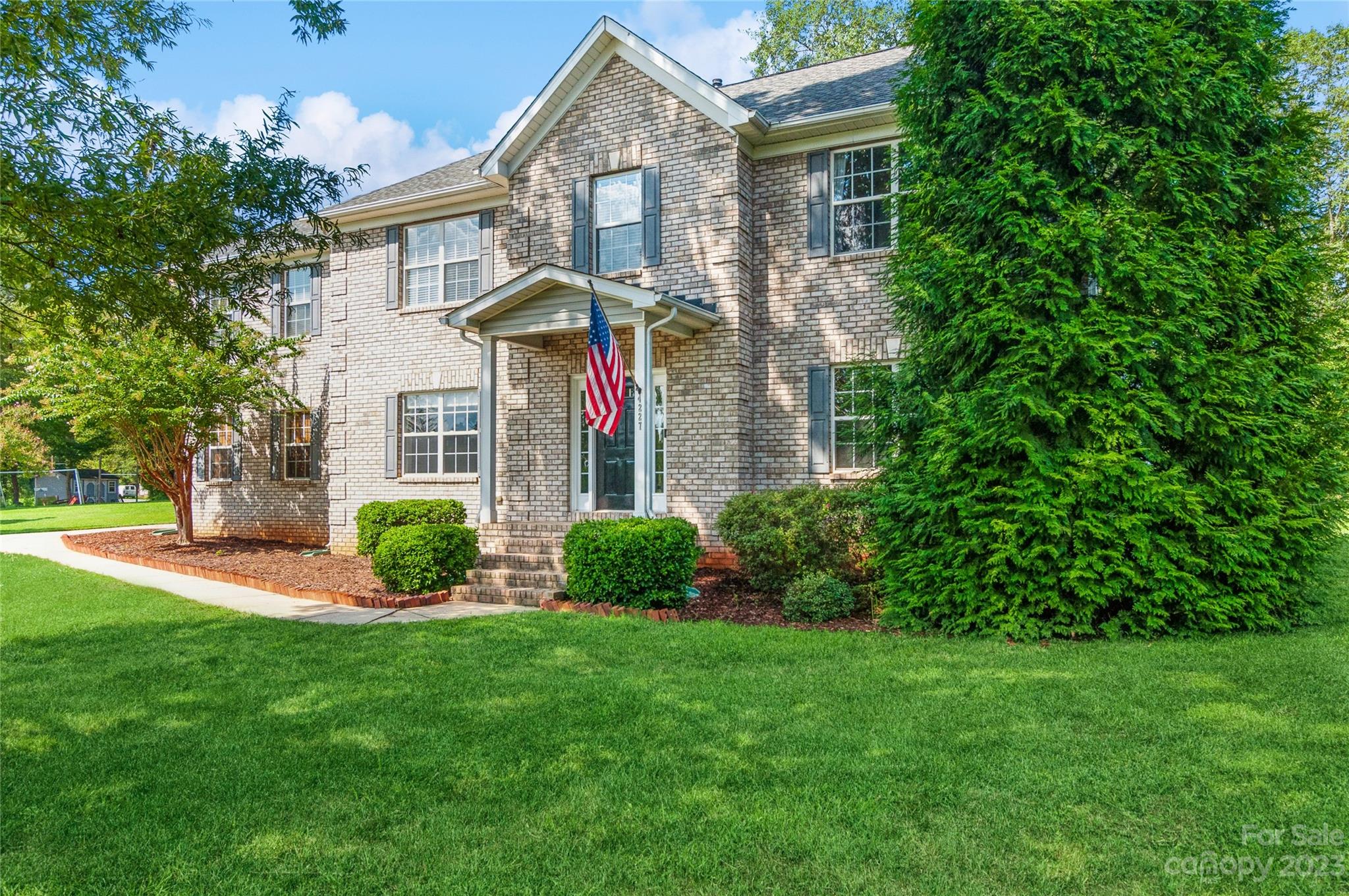 4227 Flint Drive Lancaster, SC 29720 - Photo 3 of 39 a front view of a house with a yard and potted plants