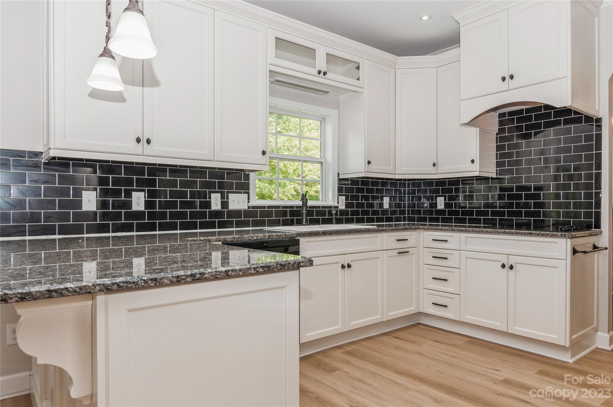 4227 Flint Drive Lancaster, SC 29720 - Photo 8 of 39 a kitchen with granite countertop a sink a stove and cabinets
