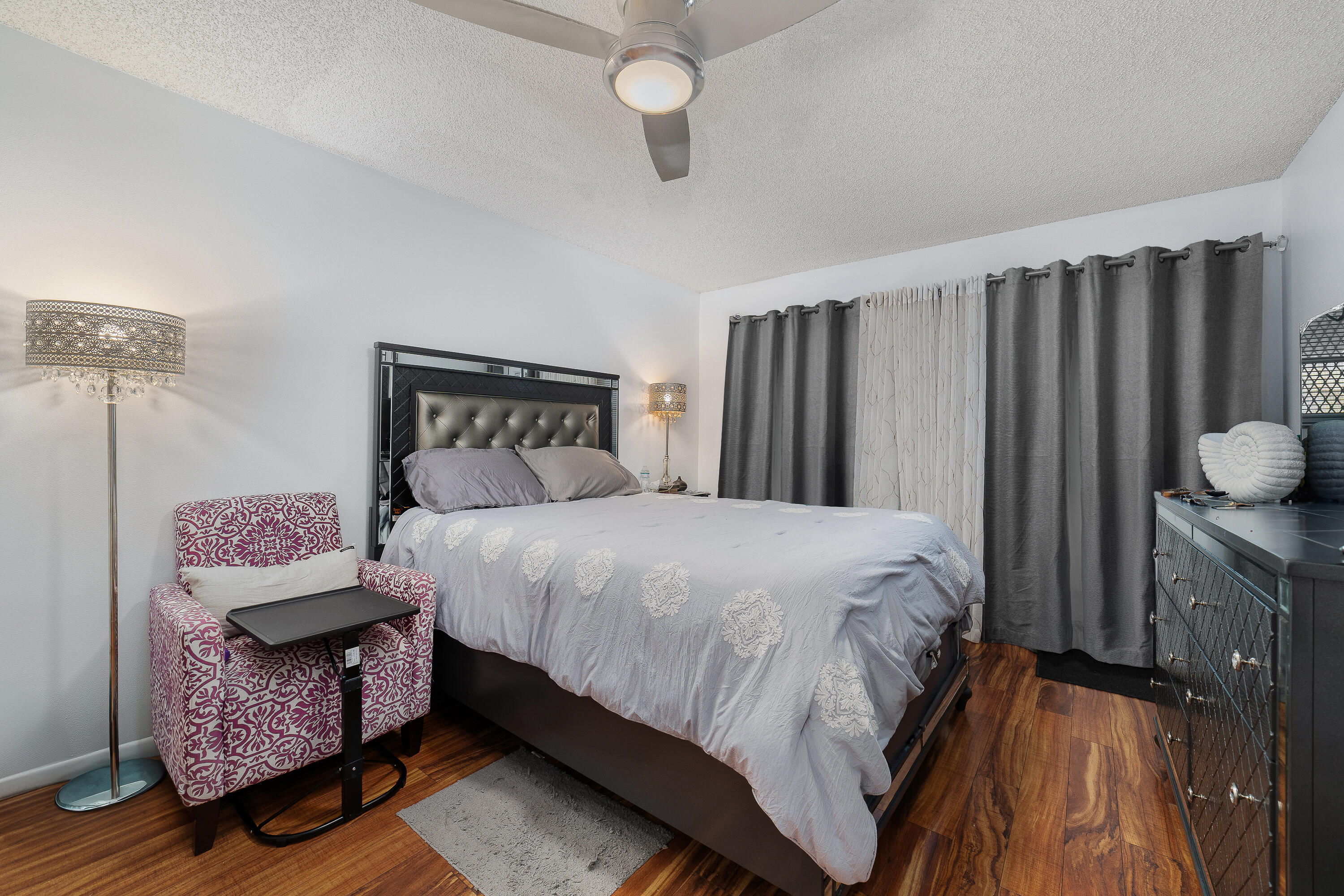 3331 Valley Road, Unit C Boynton Beach, FL 33435 - Photo 15 of 28 a bedroom with a bed a dresser and wooden floor