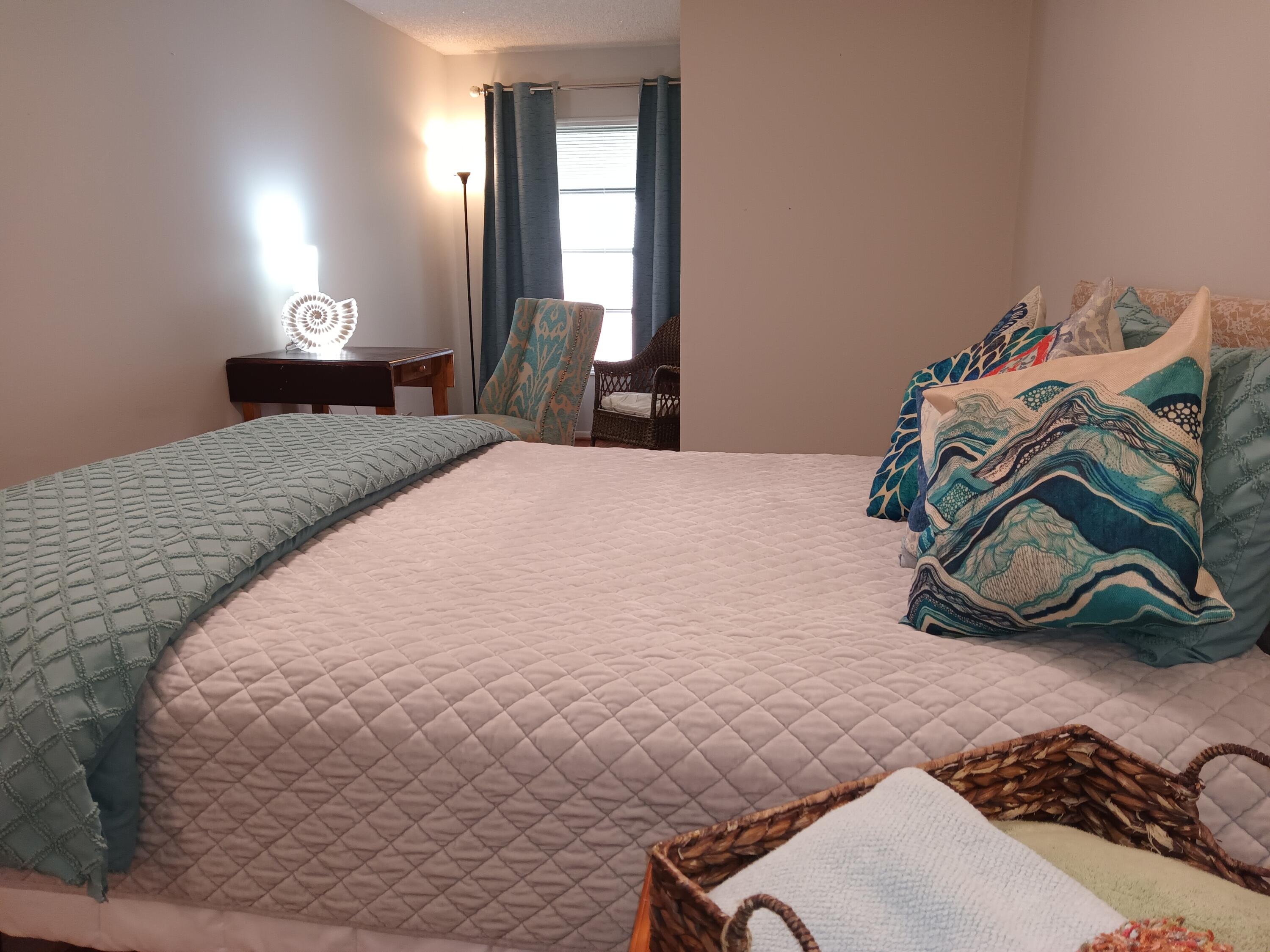 3331 Valley Road, Unit C Boynton Beach, FL 33435 - Photo 17 of 28 a bedroom with a bed and a chair