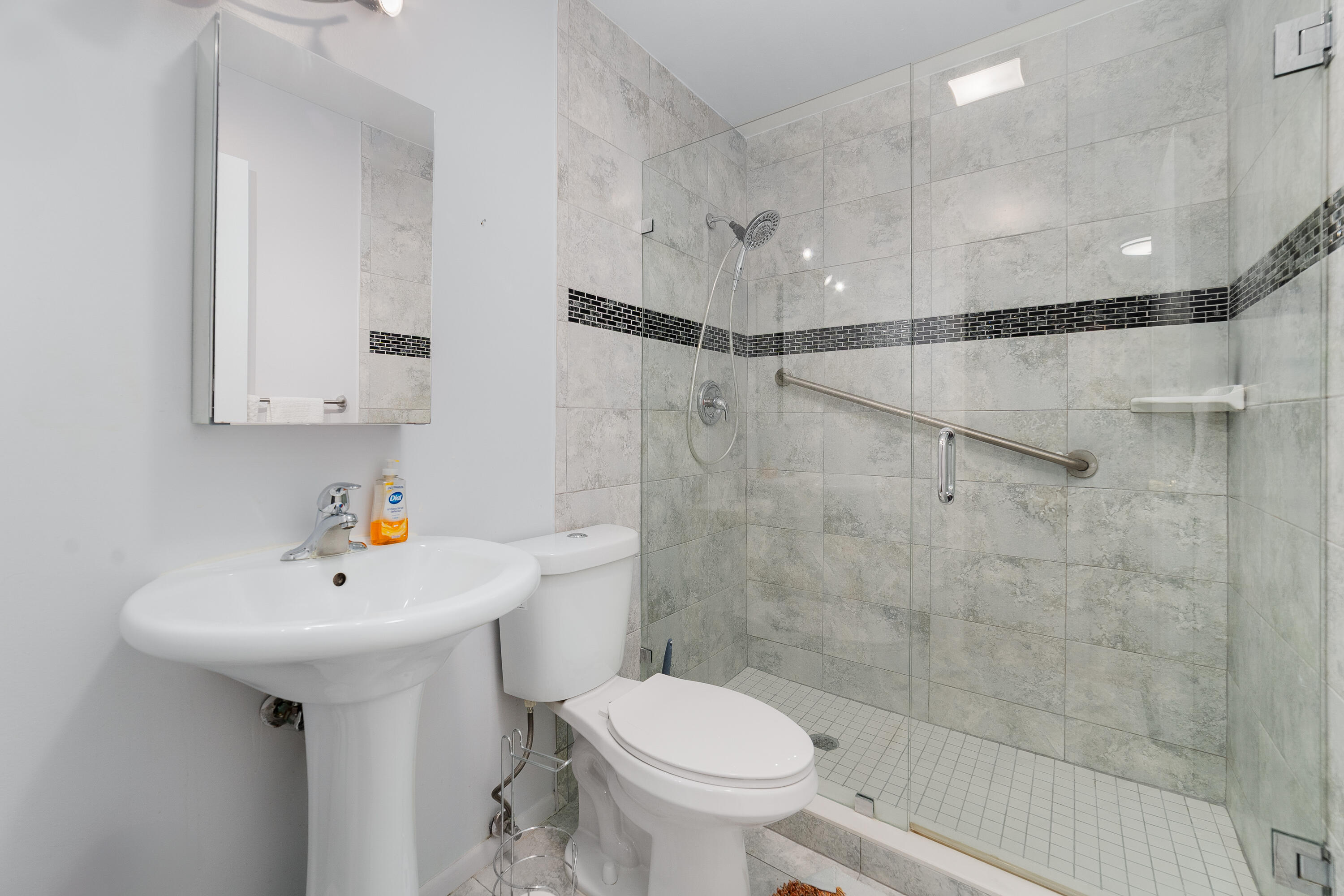 3331 Valley Road, Unit C Boynton Beach, FL 33435 - Photo 20 of 28 a bathroom with a sink toilet and shower