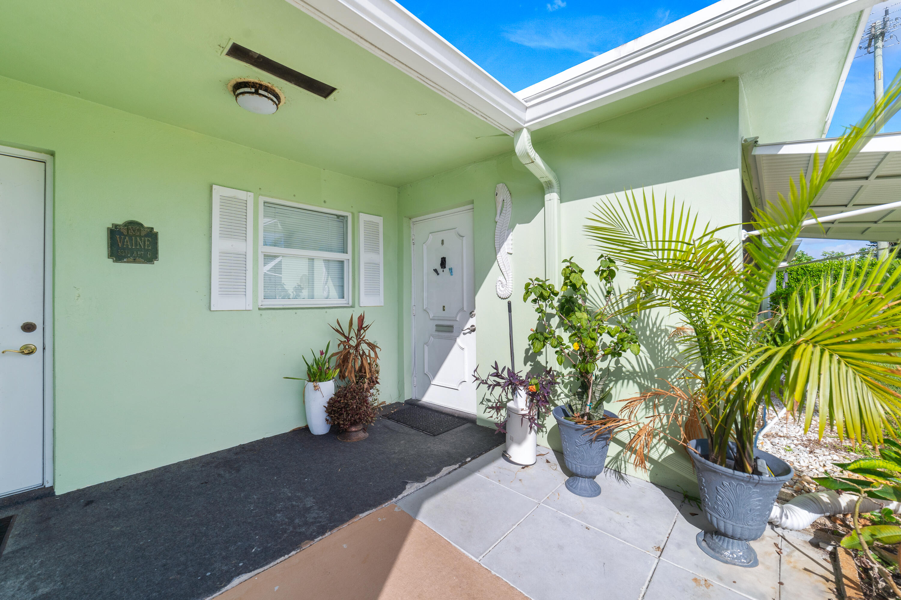 3331 Valley Road, Unit C Boynton Beach, FL 33435 - Photo 2 of 28 a vase of flowers sitting on a floor