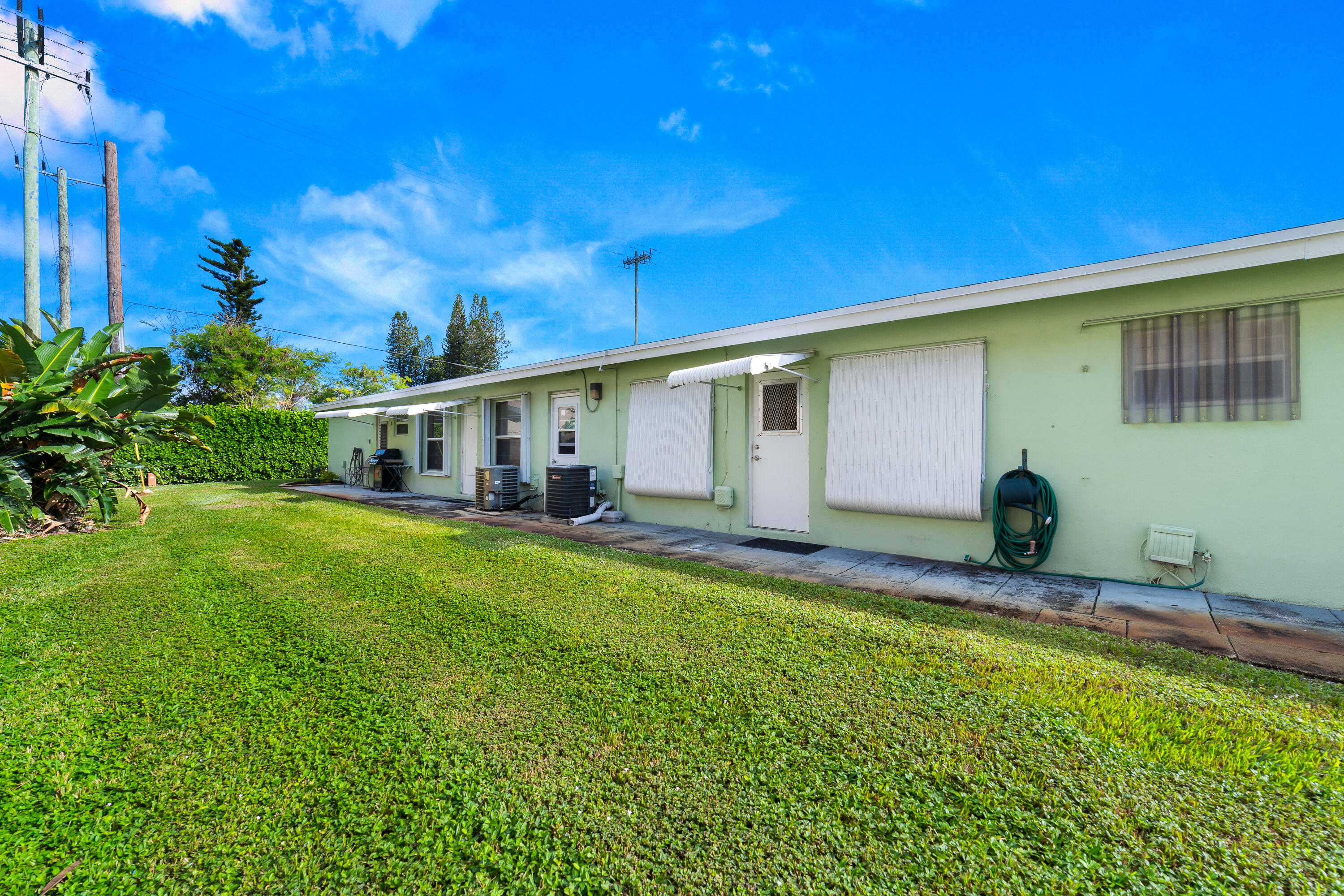 3331 Valley Road, Unit C Boynton Beach, FL 33435 - Photo 22 of 28 a front view of house with yard and seating area